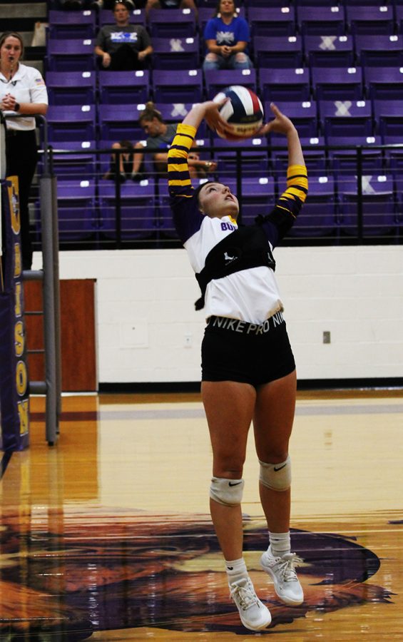 Senior Jaycee Harris sets the volleyball during a home game.