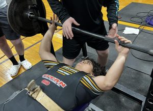 Maylene Caceres gets set to lift at a powerlifting meet at Buffalo. She will compete at state on March 16.