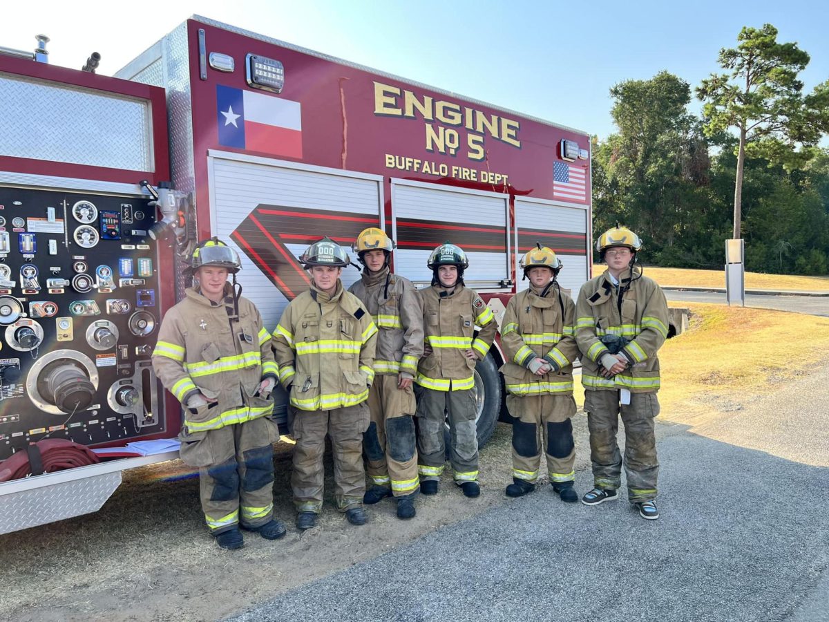Firefighter program students learn the basics, including putting on and using the gear and becoming familiar with the parts of the fire truck. 