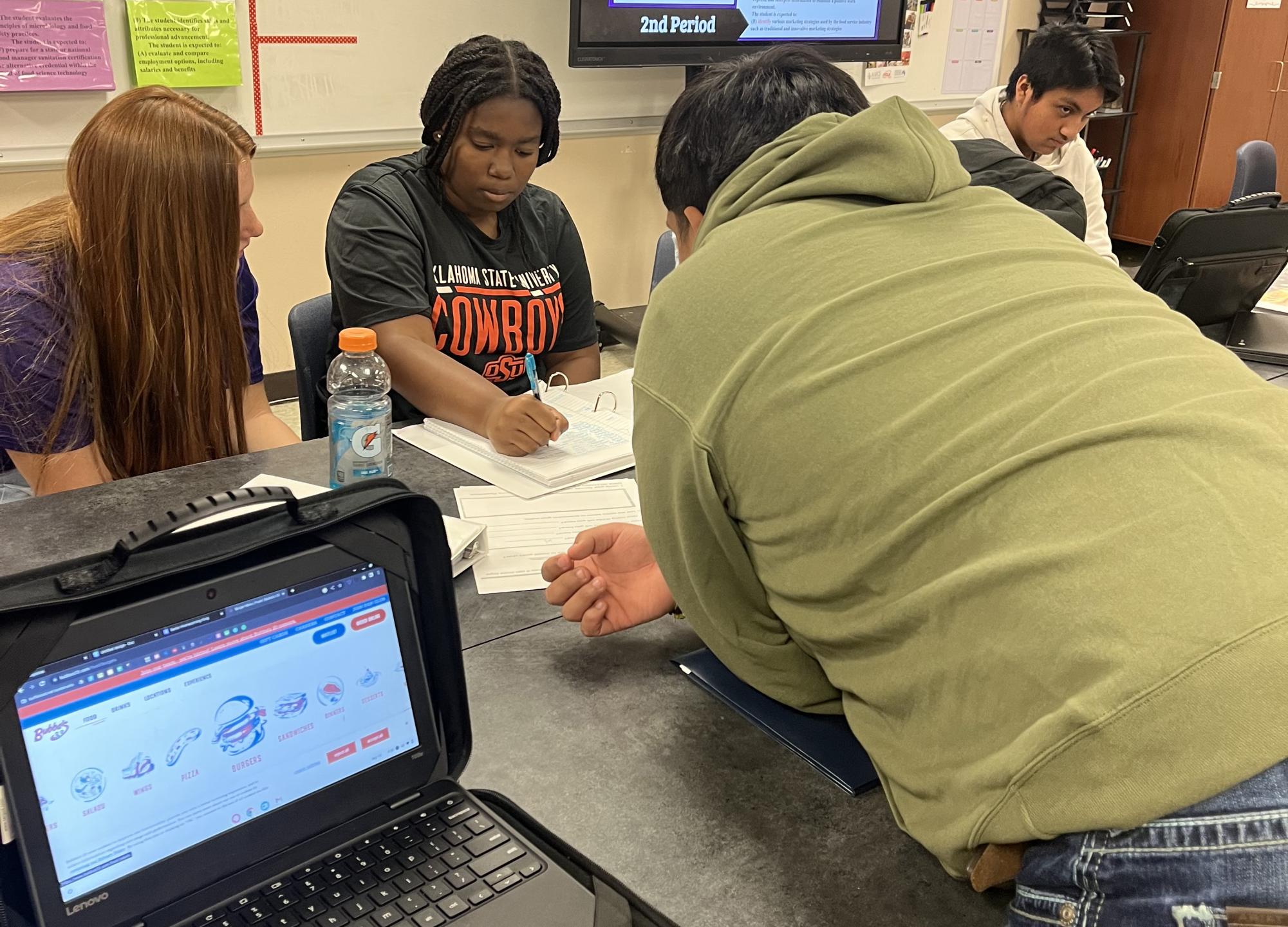 Junior Yazmin Richardson and her classmates work on their logo designs for their restaurant marketing projects. The class is taught by Chelsea Nelson.