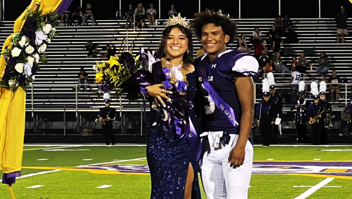 Homecoming queen Mildret Carrillo and king Aiden Savage show off their new bling for the crowd. 