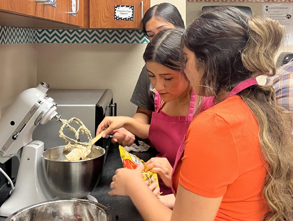 Culinary Arts students add chocolate chips to their cookie dough during their first baking project of the year. Teacher Chelsea Nelson uses the project to see how much students have retained about measuring ingredients. 