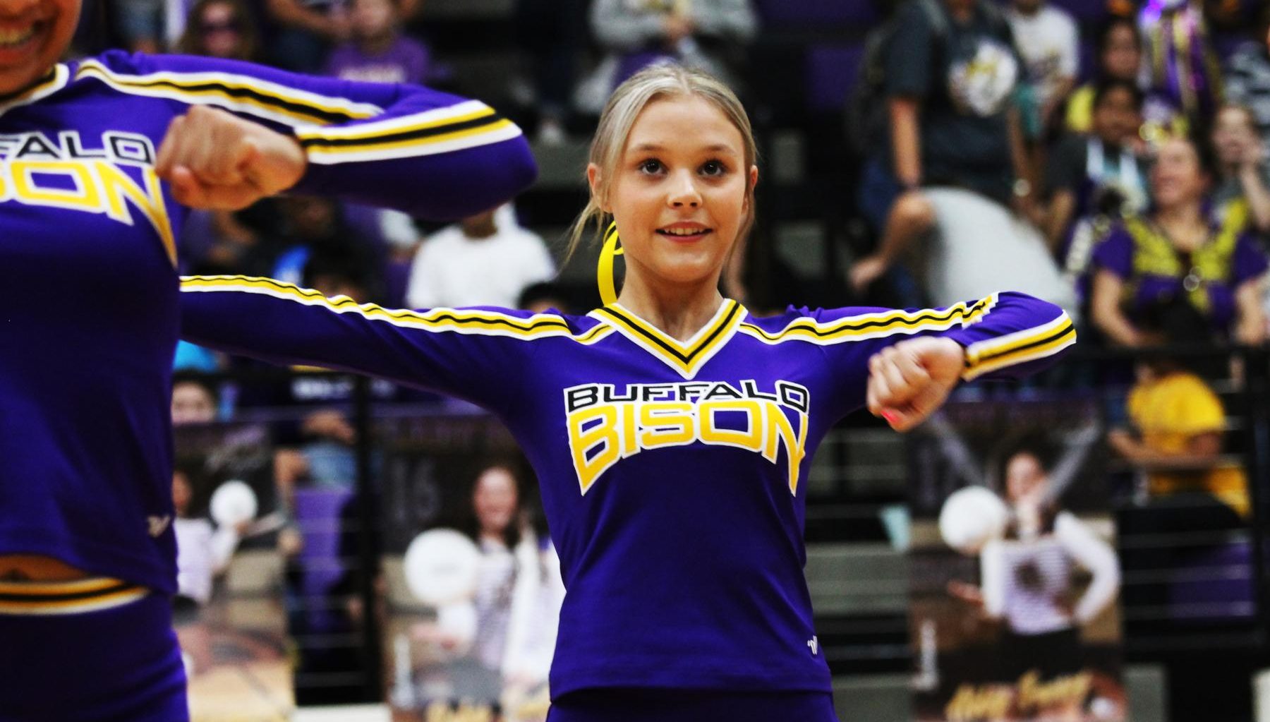 Freshman Riley Davis keeps her eyes on the crowd as she cheers at the homecoming pep rally. 