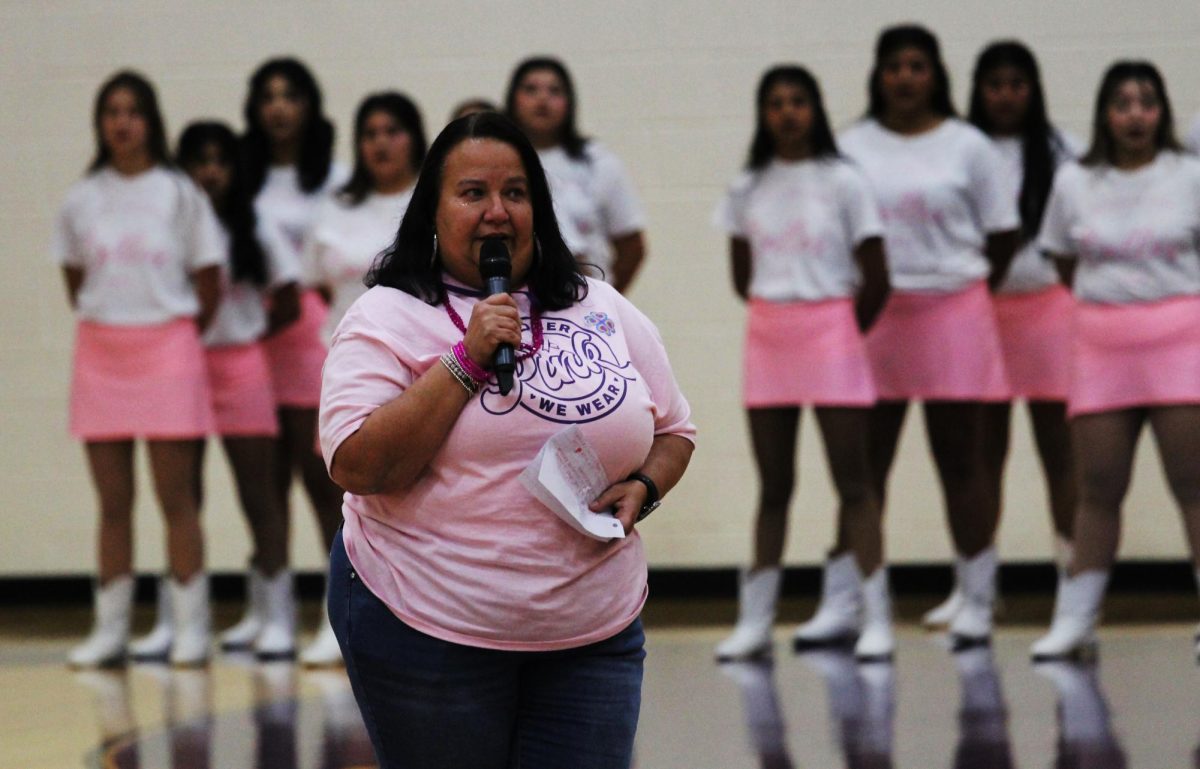 Olivia Wyatt speaks to the audience at the Pink Out Pep Rally. Her daughter Morgan is a senior on the volleyball team. 