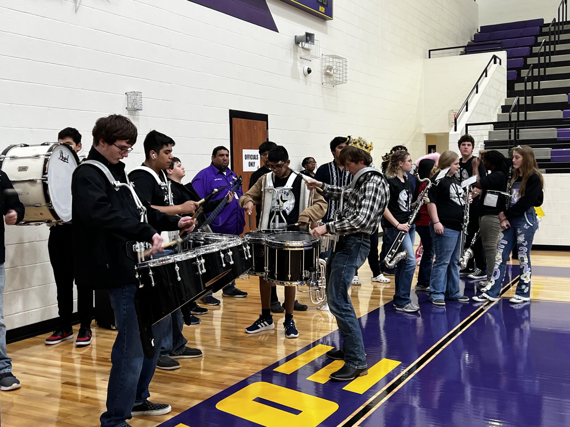 Senior Billy Duncan leads the drum line while the group waits for the senior pep rally to get started.