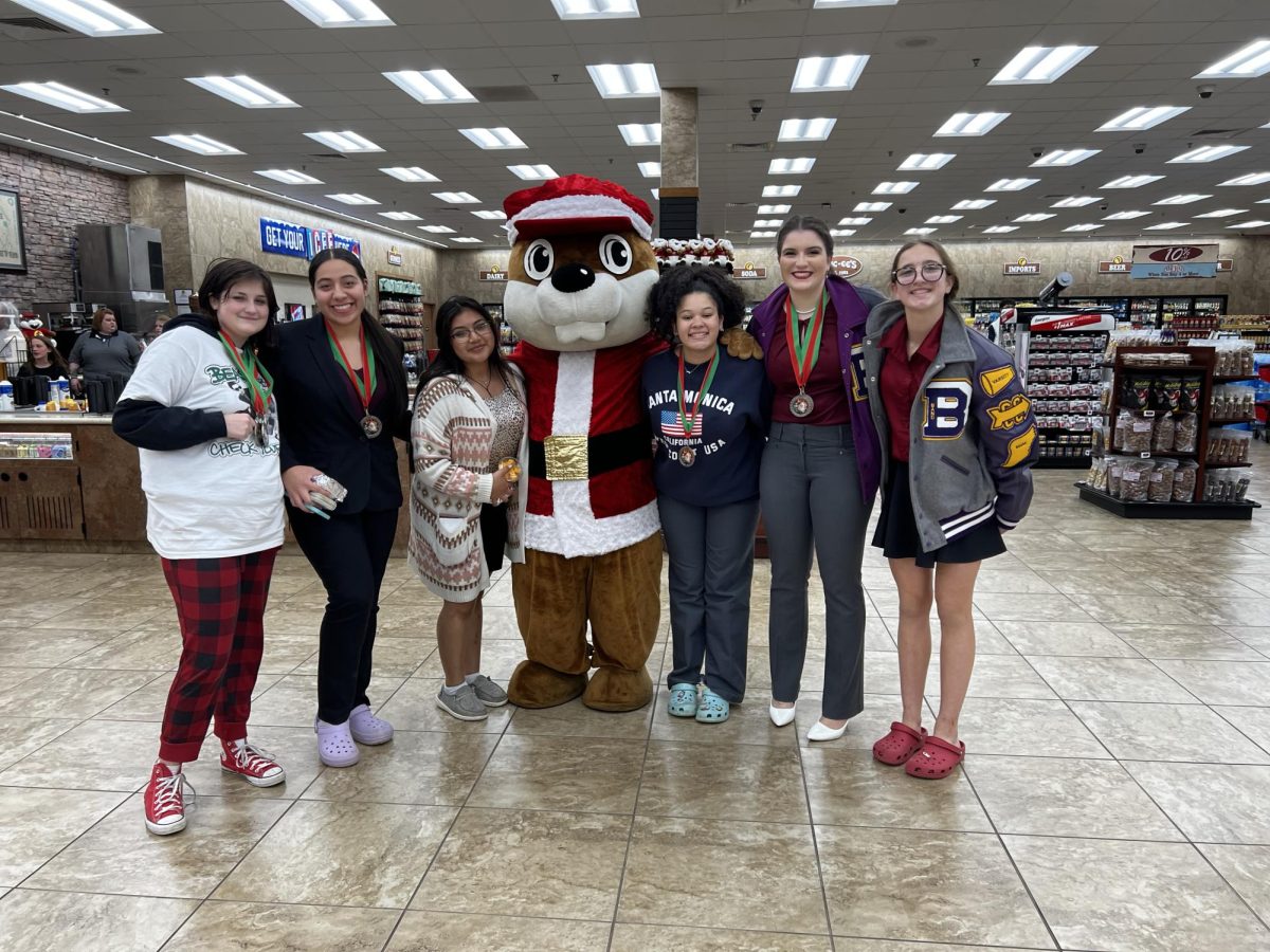 A quick stop at Buc-ees after the meet gave competitors a chance to show off their medals to the beaver. 