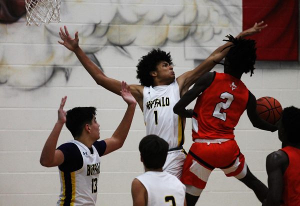 Senior Terrell Brooks goes up to block a shot in the varsity game against Teague. The team took a loss but hope to add to their win column when they start play again after Christmas. 
