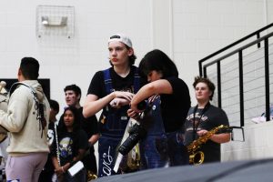 Senior Ryan Brown checks the pictures they have taken during a pep rally while photographing the event with classmate Mason Ayles. Brown hopes to medal at state in journalism again this year.