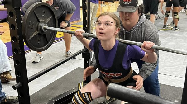 Junior Andie Kilgore focuses on her lift at a Bison powerlifting meet. The girls season ends a week earlier than the boys.