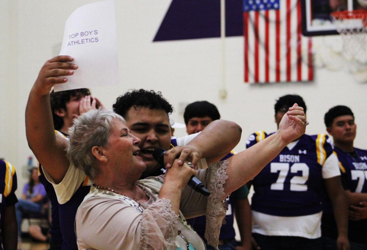 Senior Joe Caceres grabs the mic from the auctioneer to pump up the crowd and get the bids rolling during the auction portion of the evening. Meet the Bison raises thousands of dollars from fall sports and Friday night activities each year. 