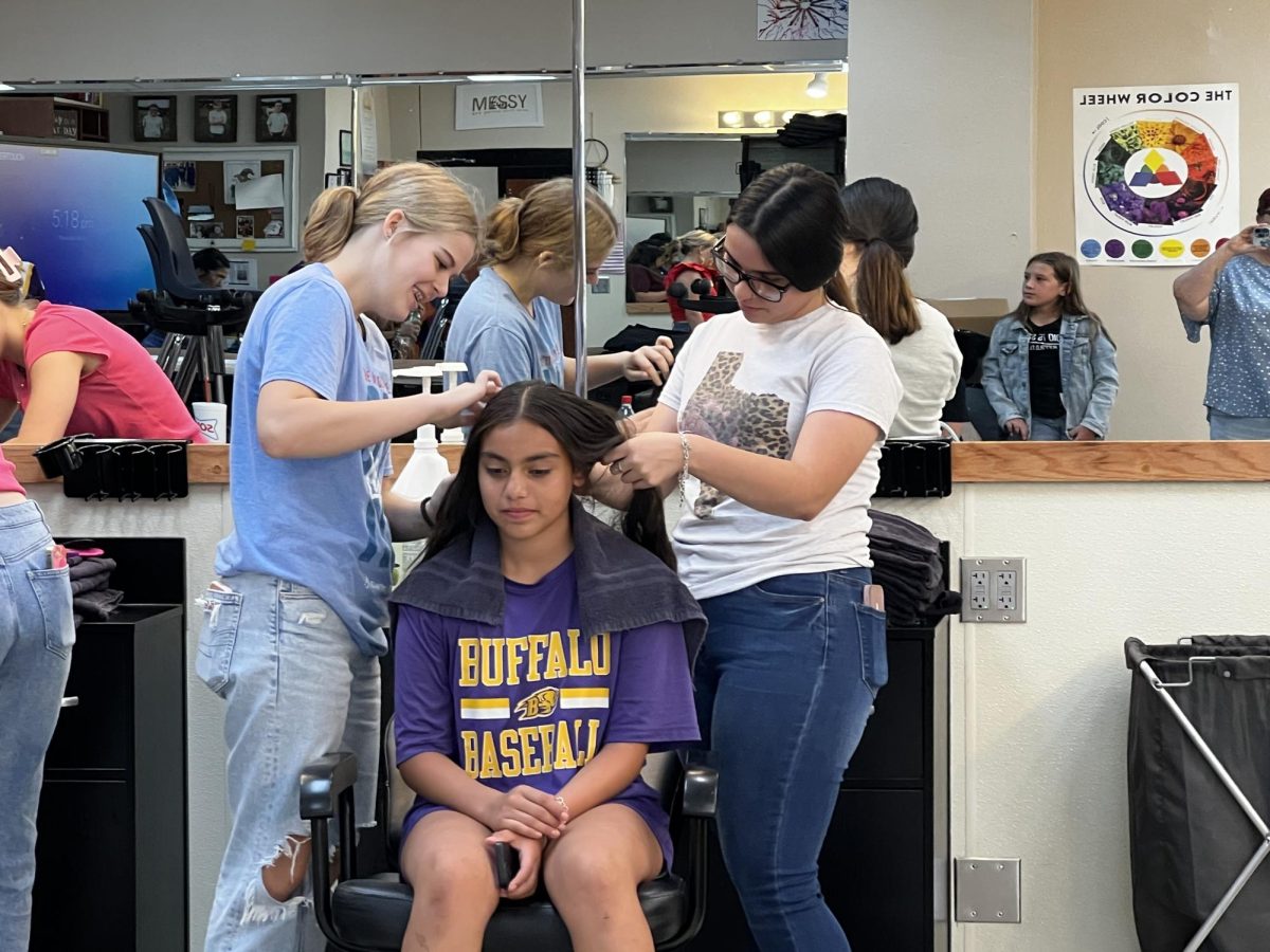 Cosmetology students help get students ready for their haircuts at the Back to School Bash. This was the second year for the event, which was open to all BISD students. 