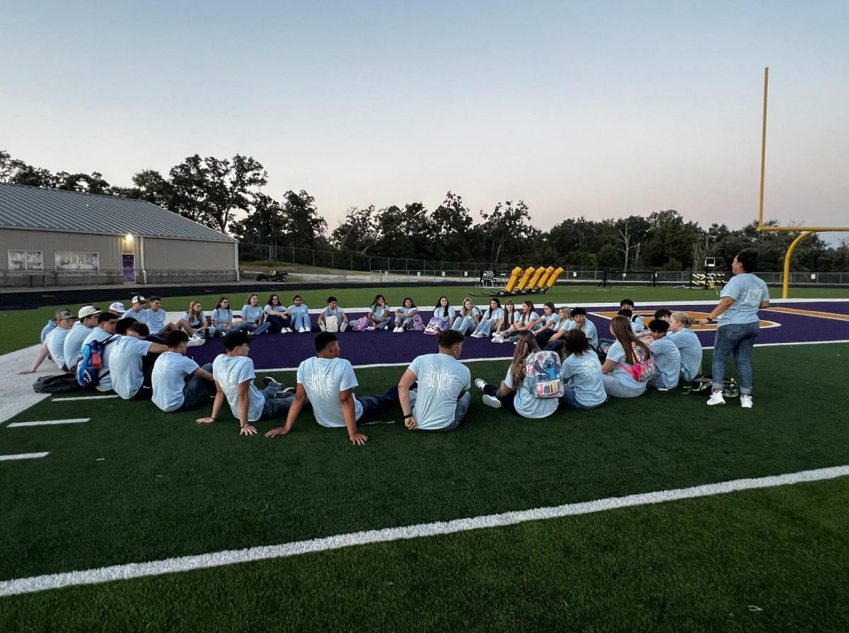 Seniors sit around and share stories with each other and sponsor Maria Salazar. The group had breakfast together before the first day of school.