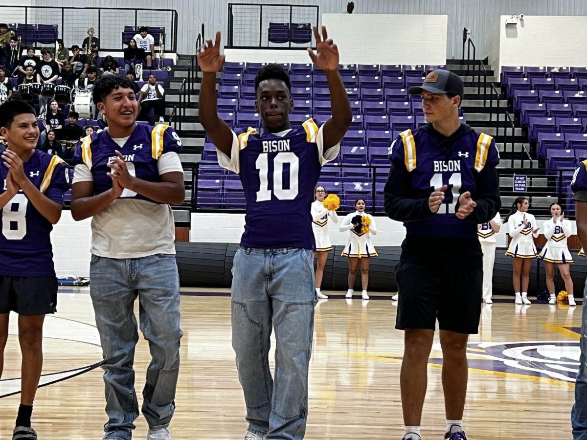 Sophomore Donte Lott waves to the crowd at Meet the Bison. This will be Lott's second year on varsity.