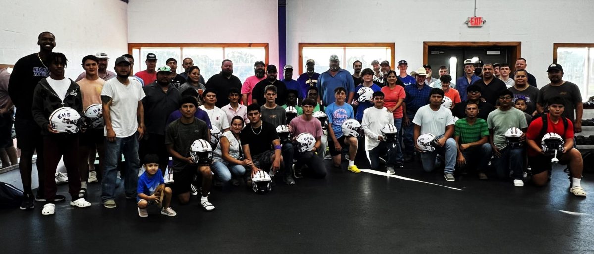 Players and dads always huddle up for a group photo when they are done with their helmets.