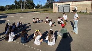 Senior Kirstyn Dennix warms the young actors up before their show on Friday. 