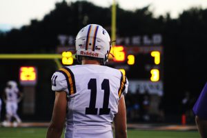 Senior Luke Brown keeps an eye on the game from the sidelines during the Buffalo/Centerville rivalry match.