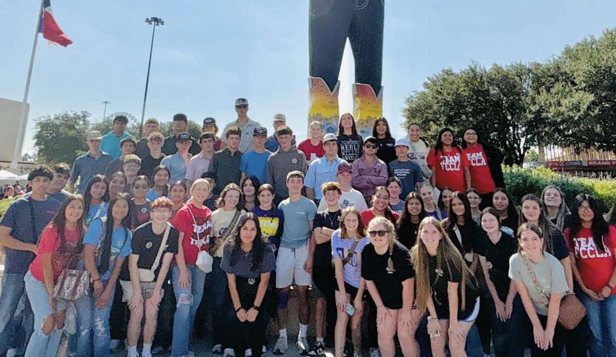 Students line up in front of Big Tex for their traditional state fair group picture. 