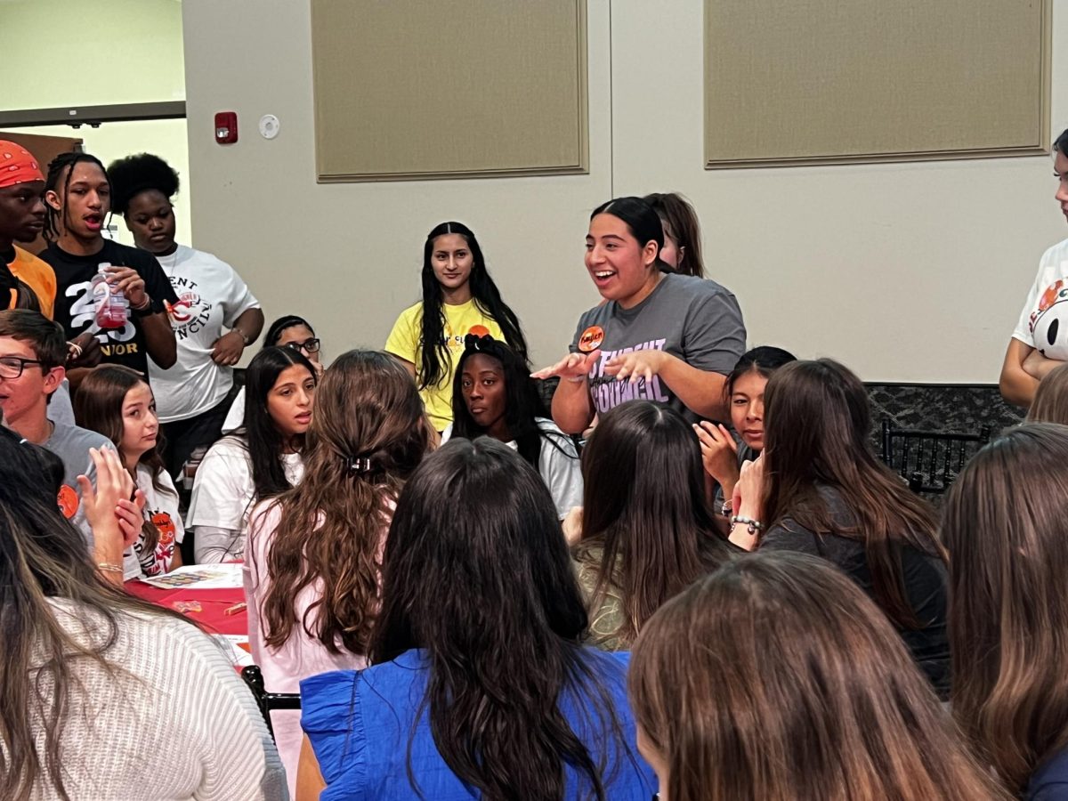 Junior Kaylen Sanchez helps her group plan their emotions skit at the StuCo District 8 Fall Leadership Conference. 