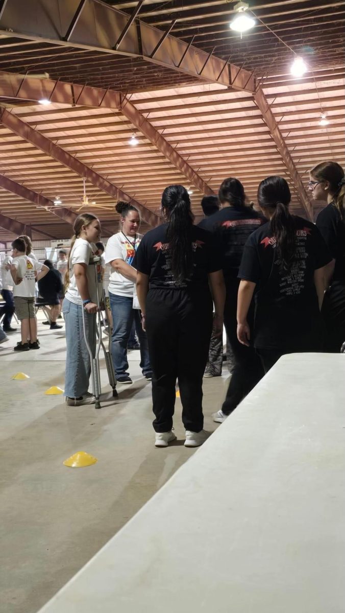 HOSA members work a booth showing students the proper way to use crutches.