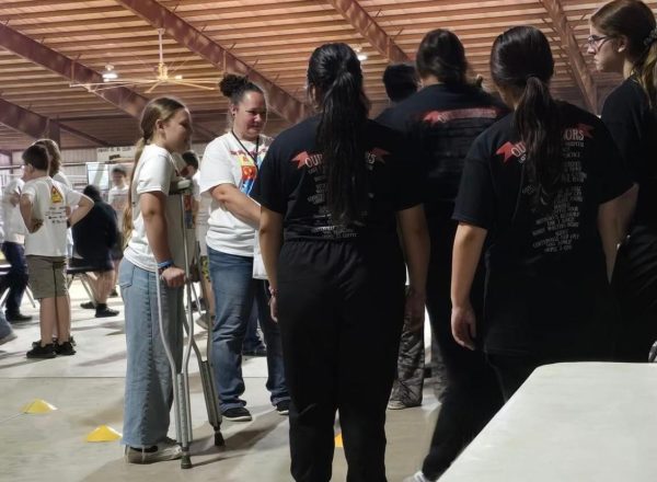 HOSA members work a booth showing students the proper way to use crutches.