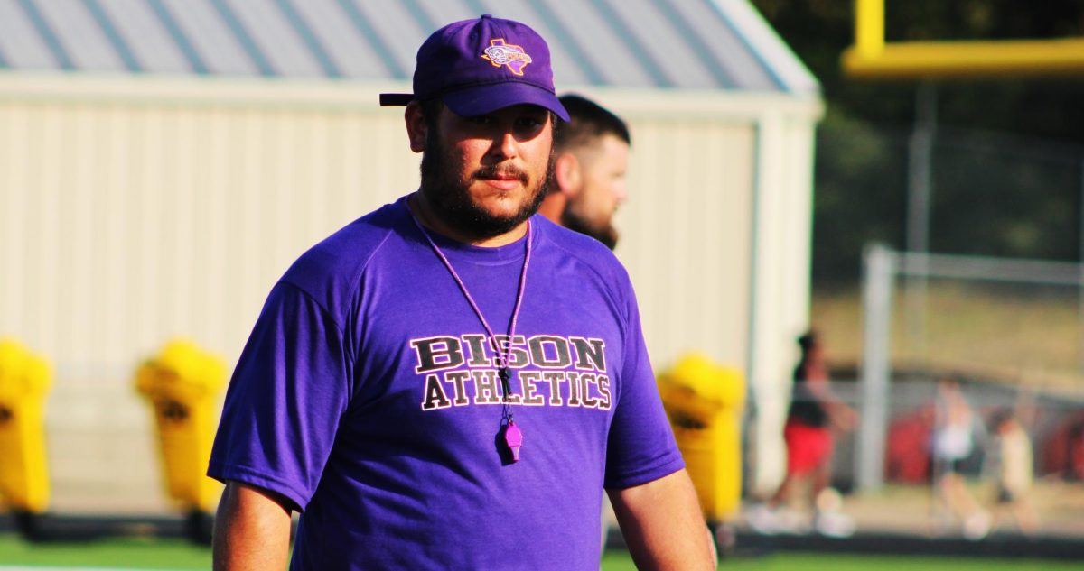 Coach Austin Ashley watches the Bison warm up before an August scrimmage.