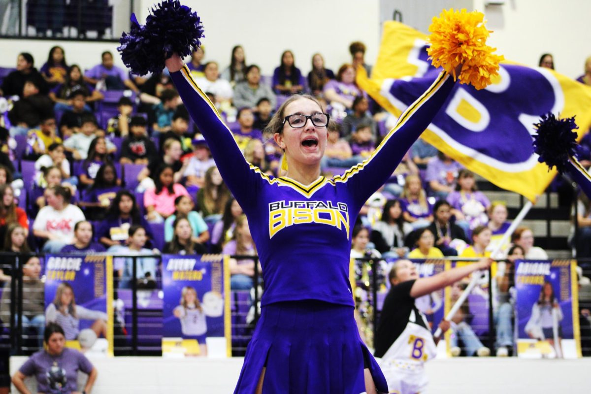 Sophomore Genevieve Arabie cheers at a pep rally.