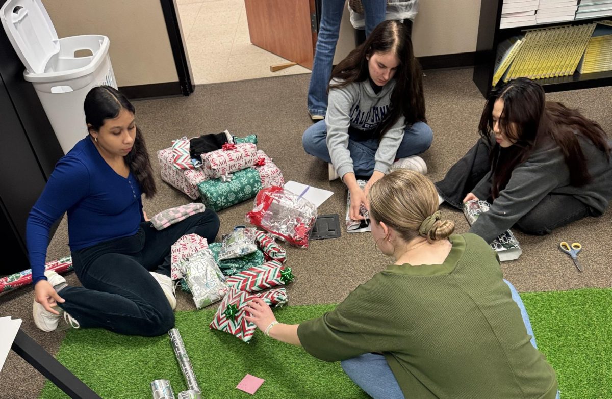 HOSA members wrap gifts to take to the Centerville nursing home. Members passed out cards and gifts, visited with the residents and sang Christmas carols. 