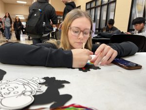 Senior Kirstyn Dennix grabbed a spot at the table to decorate her Christmas ornament. The Student Council has also hosted a friendship bracelet table and giving thanks cards for Thanksgiving. 