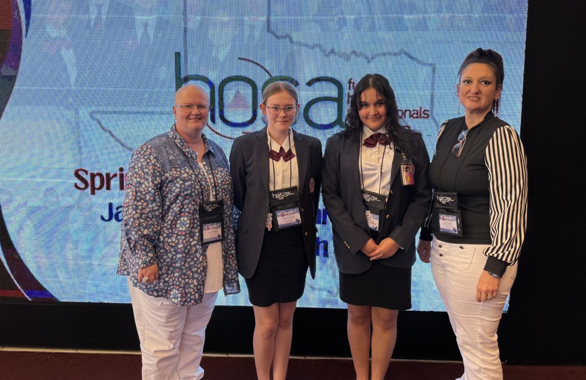 HOSA members Kirstyn Dennix and Laylanie Montano pose witht heir advisers Jeannette Lehman and Stacy Cornett at a conference in Houston.