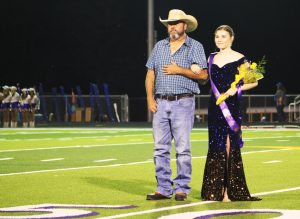 Andie Kilgore is escorted by her father Ricky at halftime of the Homecoming game. 